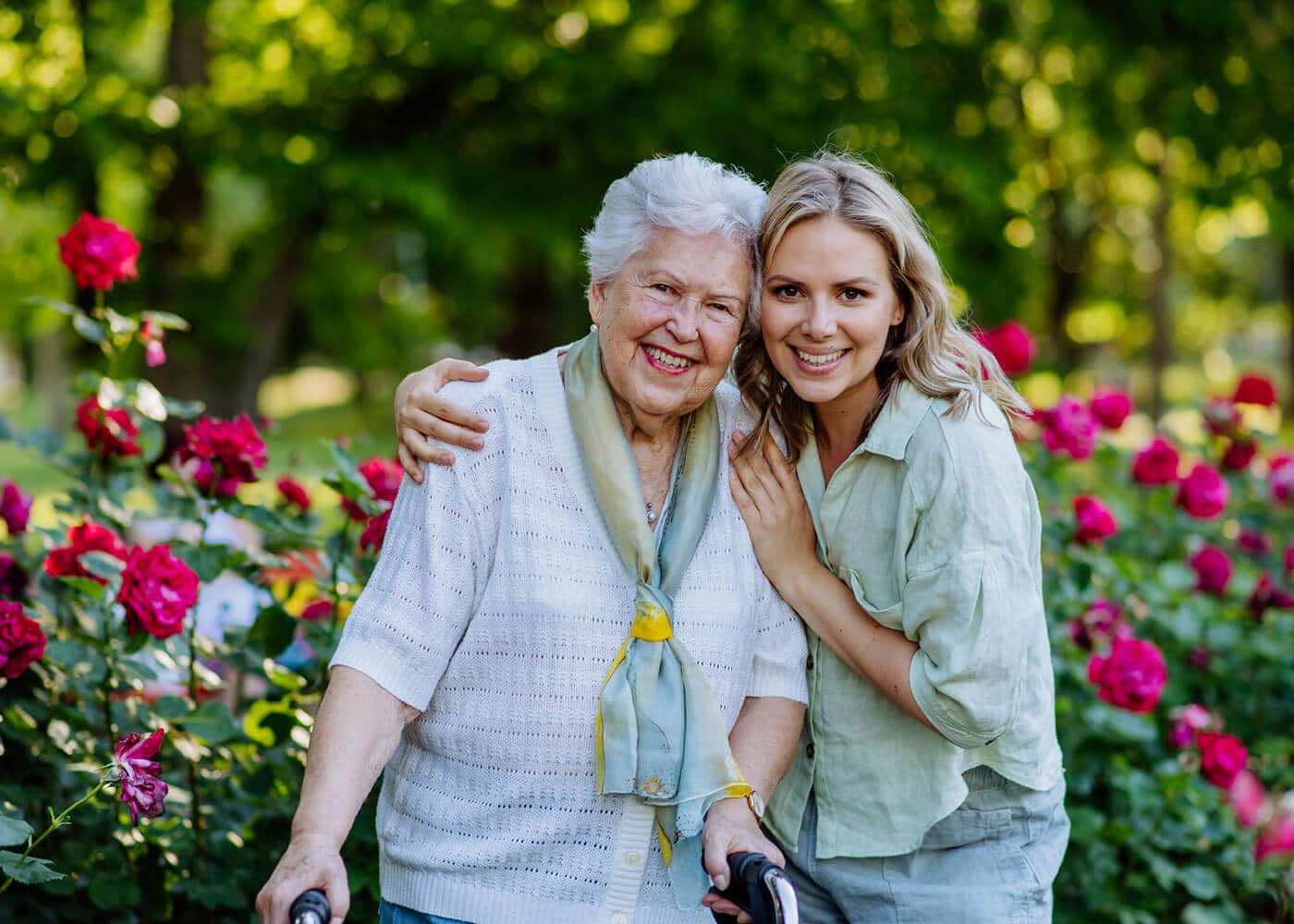 mother and daughter posing for picture in the rose garden