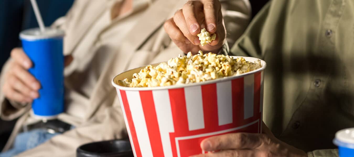 Residents watching a movie and eating popcorn